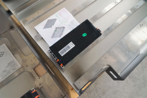 Die hintere Batteriekiste des eLandys, von oben gesehen. Sie ist offen, und noch nicht fertig bestückt. Man sieht ein Akku-Modul sowie den Bauplan der Batterie